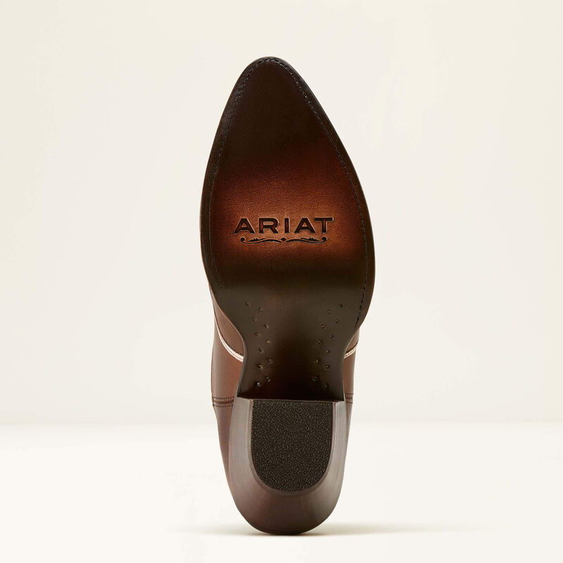 Brown leather boot sole with 'Ariat' branding on a beige background